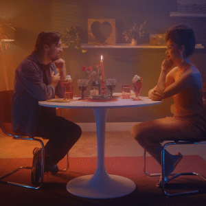 lady and man sitting across from each other in a romantic dinner scene